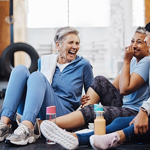 Group of adult women laughing together at gym