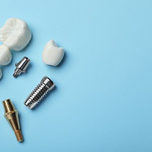 various dental implant parts with a blue background