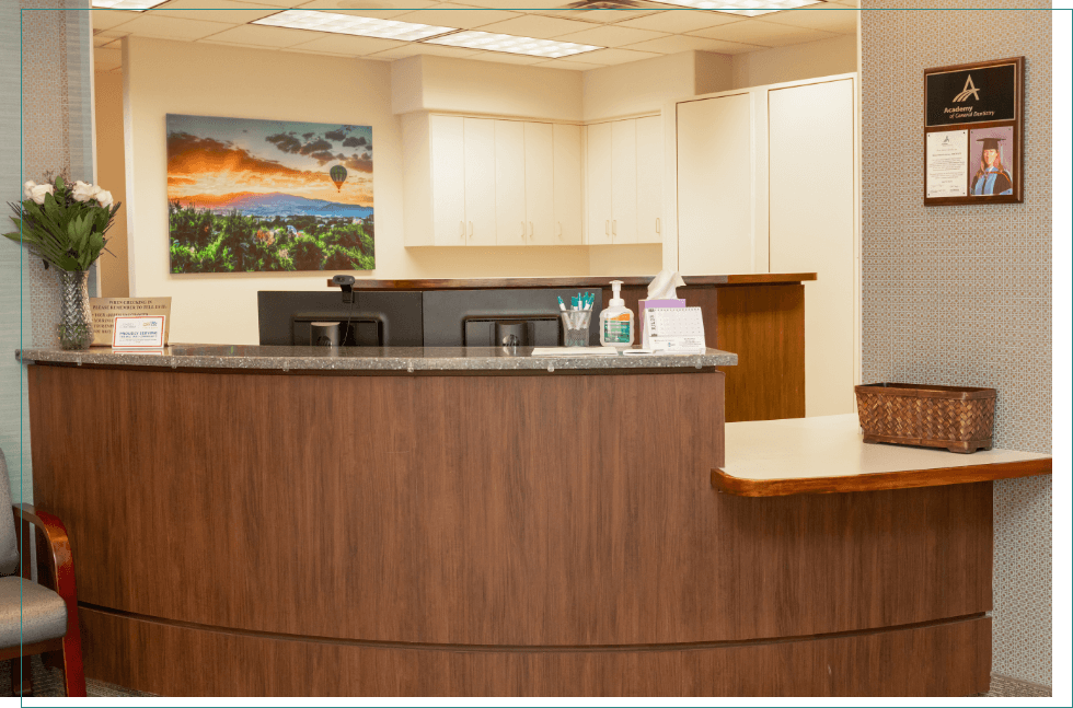 Front desk with painting of sunset on wall