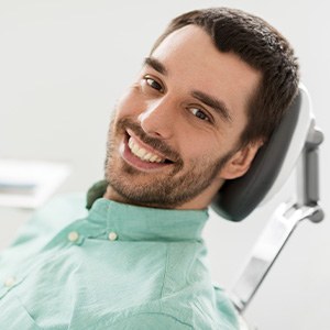 Patient smiling while sitting in treatment chair