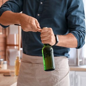 Man opens bottle with opener