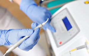 Dental team member preparing to use soft tissue laser